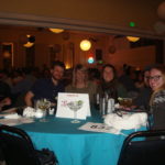 Image of group of people at round table smiling