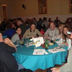 Image of people sitting at table smiling