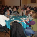 Image of people sitting at a table smiling