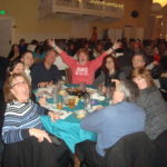 Image of people sitting at a table smiling