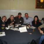 People sitting at table posing for picture