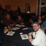 Image of people sitting at table posing for picture