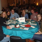 Image of people sitting at a table smiling