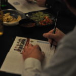 Image of person writing in book