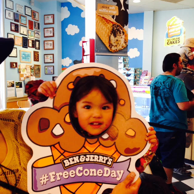 Image of little kid in cut out free cone day