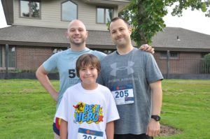 Image of two men and a boy before running a race